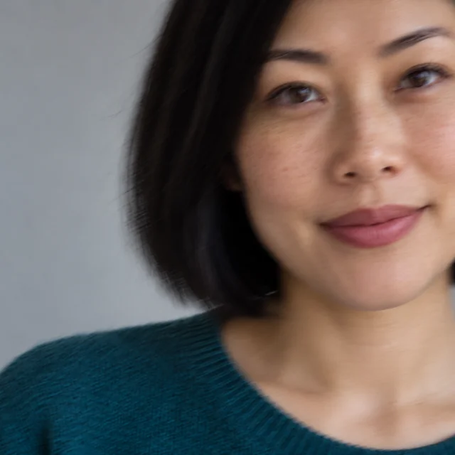 Blurry portrait of the same fictional adult with the face partly cropped